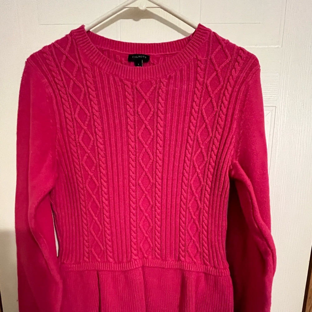 Cute bright pink sweater. Ruffle on bottom.